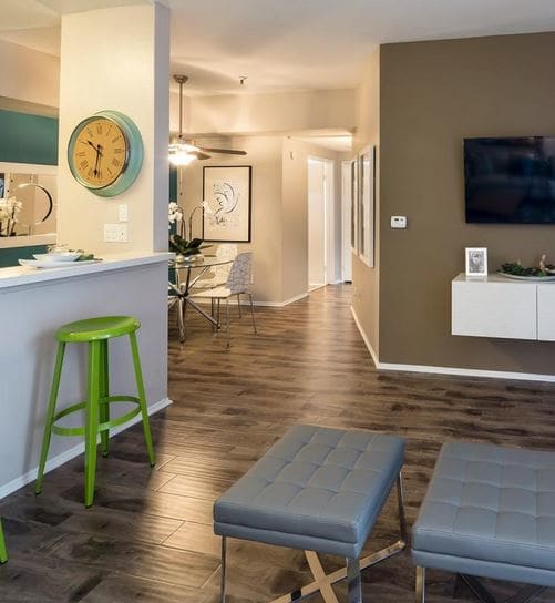 a living room filled with furniture and a flat screen tv