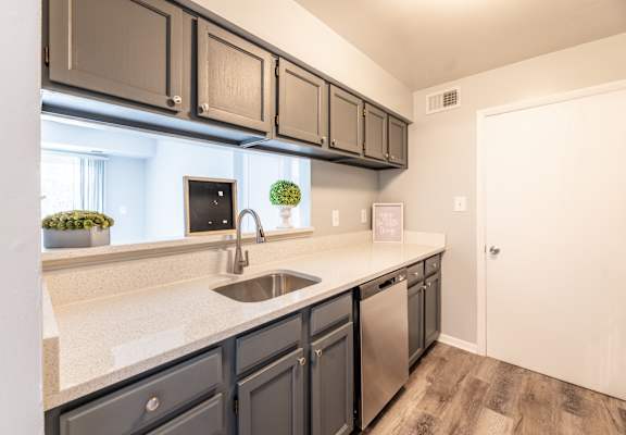 a kitchen with a sink and a dishwasher at BellaVista Apartments in Woodbridge, VA