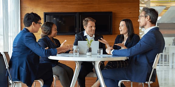 A group of business people having a meeting around a table.