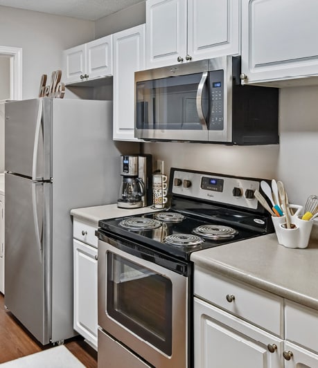 a kitchen with stainless steel appliances and white cabinets