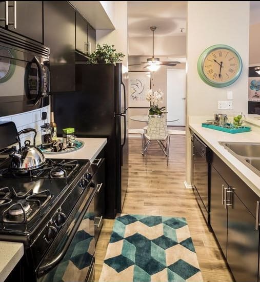 a kitchen with a stove top oven next to a sink