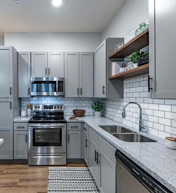 A modern kitchen with a white table and chairs.