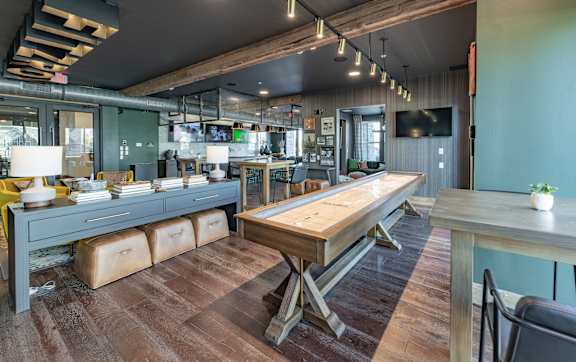 A modern kitchen with stainless steel appliances and wooden cabinets.