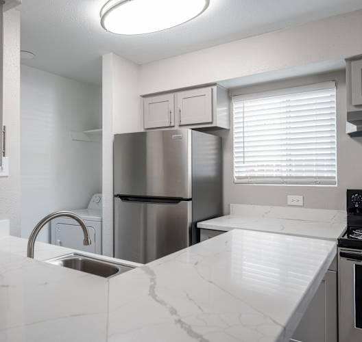 Kitchen with white counter at Brook Meadow Village, Austin, TX