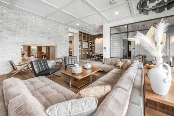 a living room with couches and chairs and a fireplace at The Haven at Lake Britt Apartments, Winter Garden, FL 34787