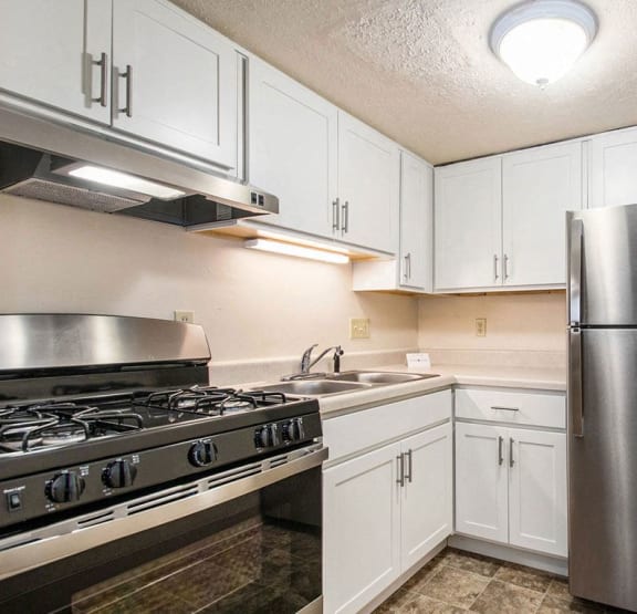 Kitchen with White Cabinets at Normandy Village Apartments, Michigan City