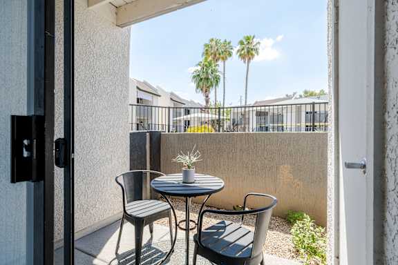 A patio with a table and two chairs.