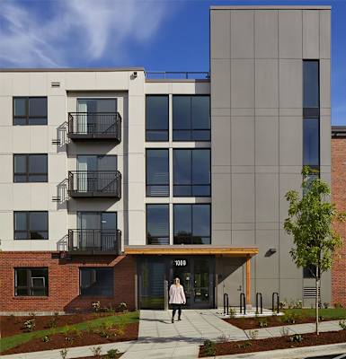a woman walking in front of a building