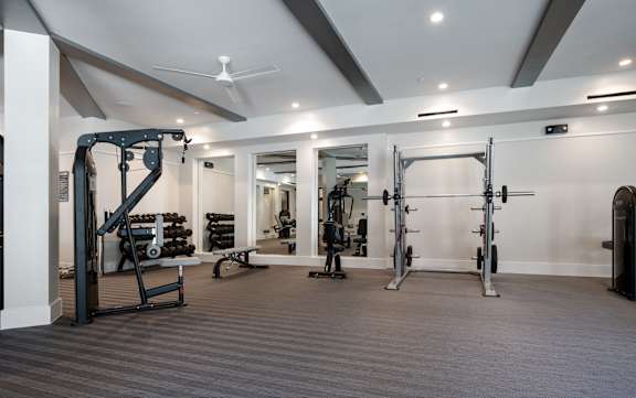 A spacious gym with a variety of equipment.