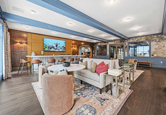 A living room with a couch, chairs, and a rug. at Maison Apartments, Westerville, Ohio
