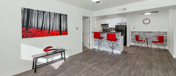 A room with a ceiling fan and a painting of a forest on the wall at Urban WalkApartments on 6th Avenue, Phoenix 85016