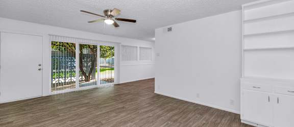 A room with a ceiling fan and wooden flooring at The Phoenix Apartments on 6th Avenue, Phoenix