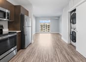 Thumbnail 4 of 9 - A modern kitchen with wooden cabinets and stainless steel appliances.