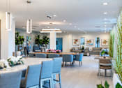 Thumbnail 4 of 6 - A modern office space with grey chairs and a long table.