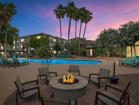 a swimming pool with a fire pit at dusk at Montage at Pecos Ranch Apartments, Chandler, AZ, 85286