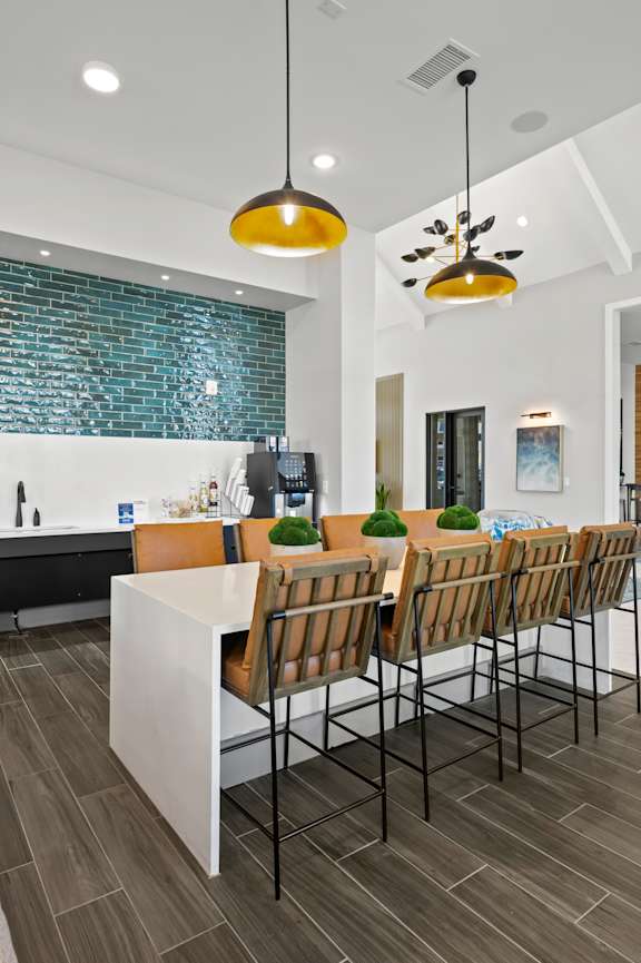 A modern kitchen with a dining table and chairs.