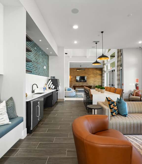 A modern living room with a long table and chairs.