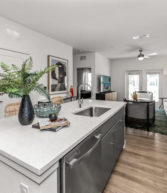 an open kitchen with a large island and a living room with a couch