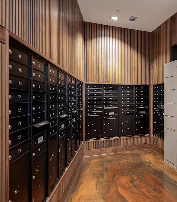 a wine cellar with white cabinets and wooden floors and a machine in the middle