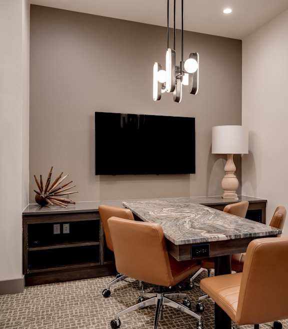 a conference room with a table and chairs and a tv