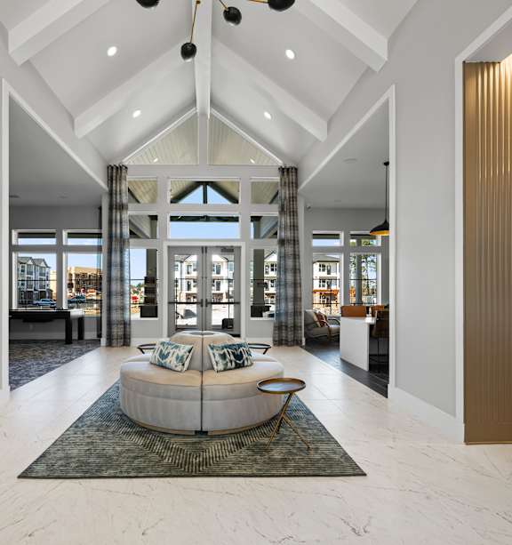 A modern kitchen with white cabinets and stainless steel appliances.