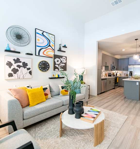 A living room with a grey couch and a coffee table.