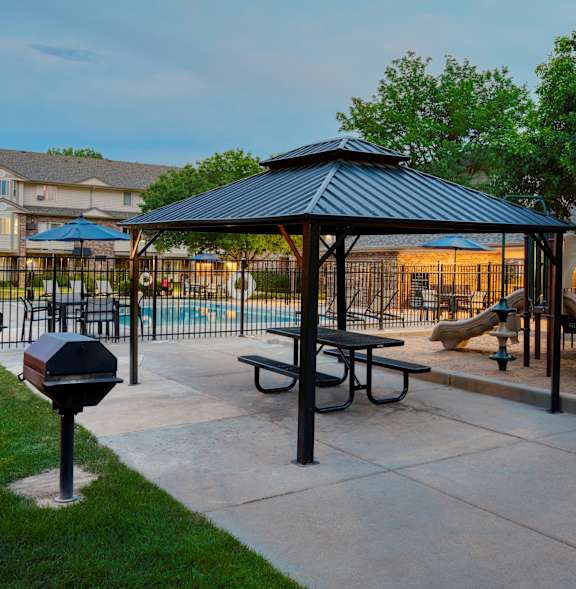 A park with a playground and a gazebo.