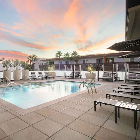 A pool area with chairs and a fountain at Cohea Archibalds.