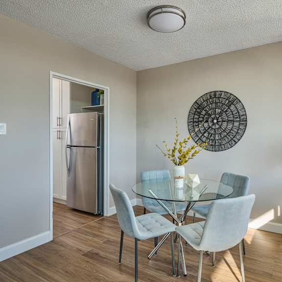 A living room with a grey couch, a round table, and a television.