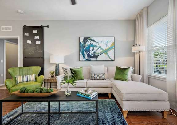 a living room with a couch coffee table and a chair