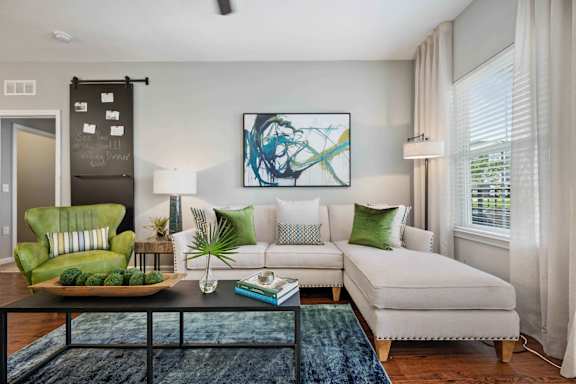a living room with a couch coffee table and a chair