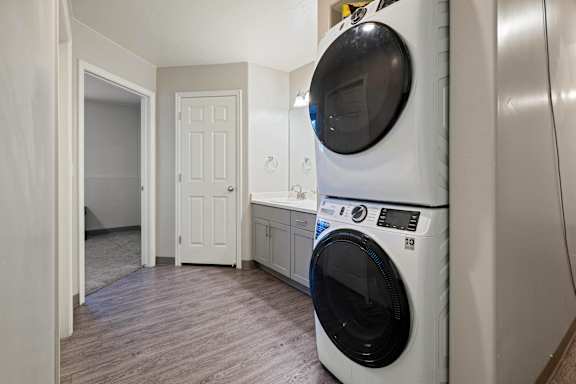 A washing machine is in a laundry room.