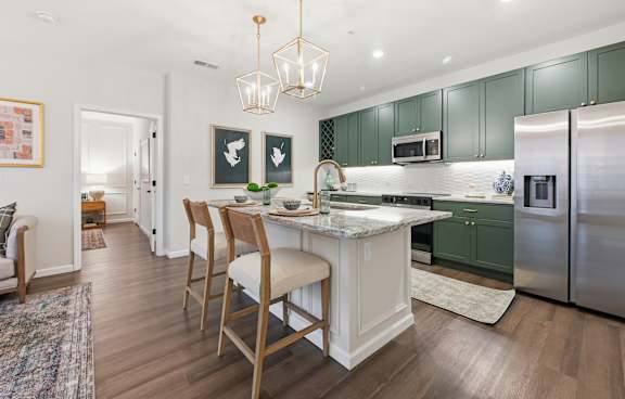 A kitchen with a table and chairs in the middle of it. at Maison Apartments, Westerville, OH, 43081