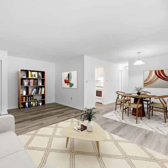 A living room with a white couch, a coffee table, and a lamp.