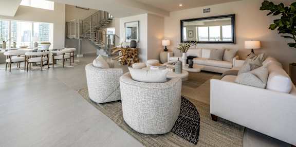 a living room with a glass table and chairs and a view of the ocean at The Hamilton, Miami, Florida