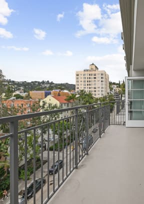 a long balcony with a view of the city The Baxter in Los Angeles, CA 90028