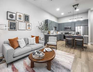 a living room with a couch and a table at The Haven at Lake Britt Apartments, Winter Garden, FL 34787