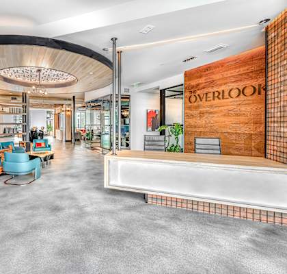 a rendering of the lobby of overlock bookstore with a reception desk and shelving