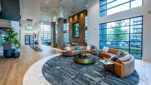a large lobby with couches and a table at 19 South Apartments in Kissimmee, FL