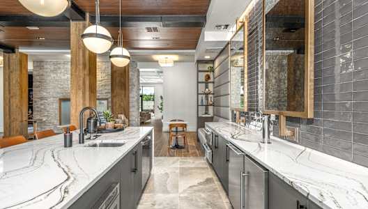 a large kitchen with two sinks and marble counter tops at The Haven at Lake Britt Apartments, Winter Garden, FL 34787