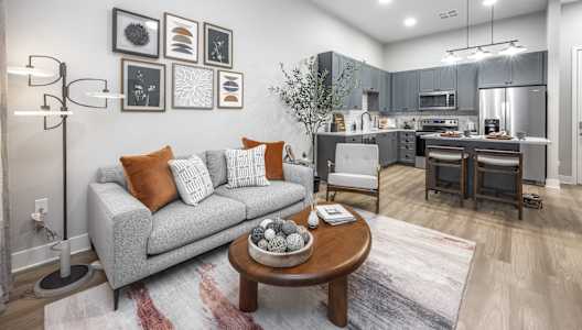 a living room with a couch and a table at The Haven at Lake Britt Apartments, Winter Garden, FL 34787