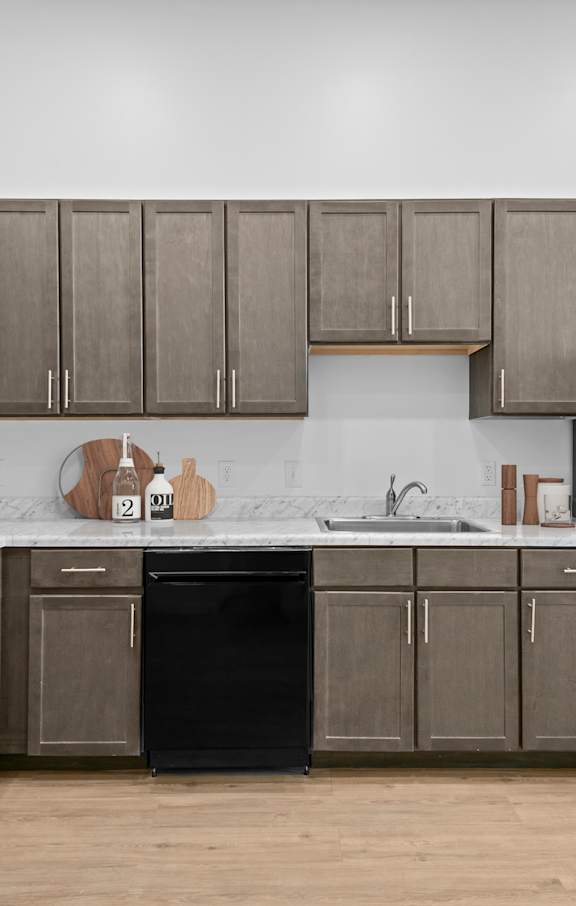Modern kitchen with brown cabinetry at 36N Apartments, Tulsa, 74106