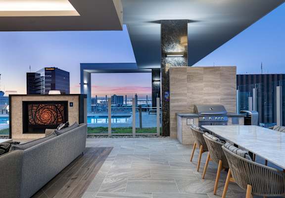 a kitchen and dining area with a fireplace and a view of the city