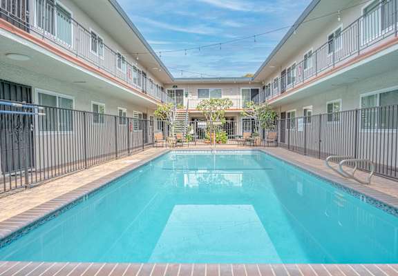 a swimming pool with a blue sky in the background