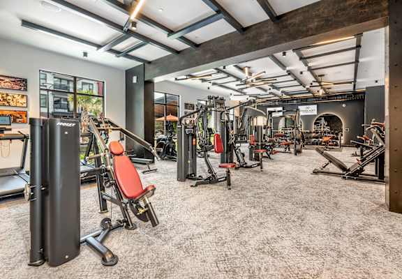 A gym with a variety of equipment including treadmills, weights, and exercise machines.at Parkway Crossings, Kissimmee, 34744