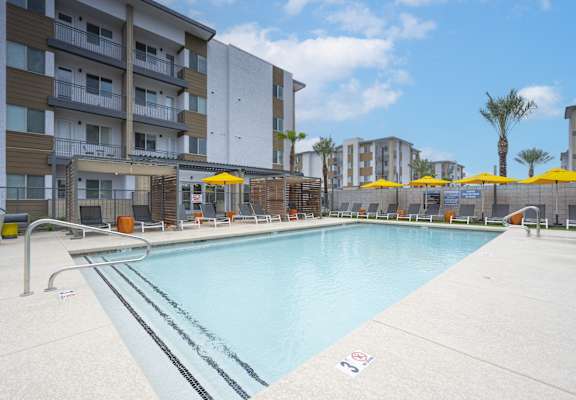 a swimming pool with a building in the background