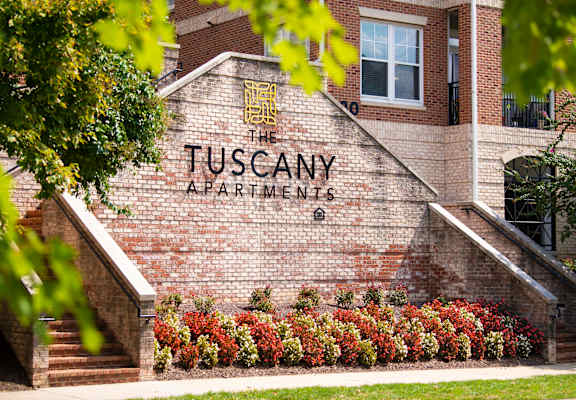The Tuscany Apartments building is made of brick.