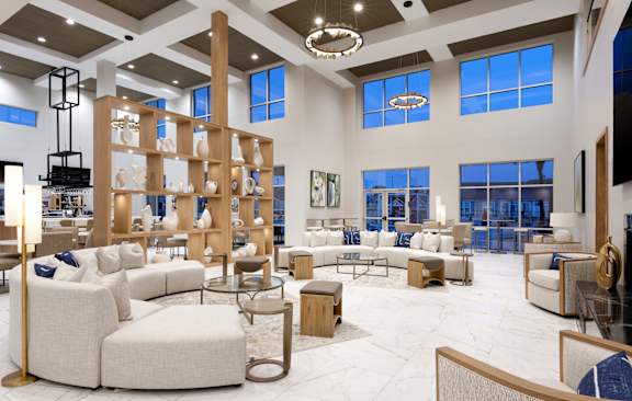 a living room with couches and tables in a furniture store