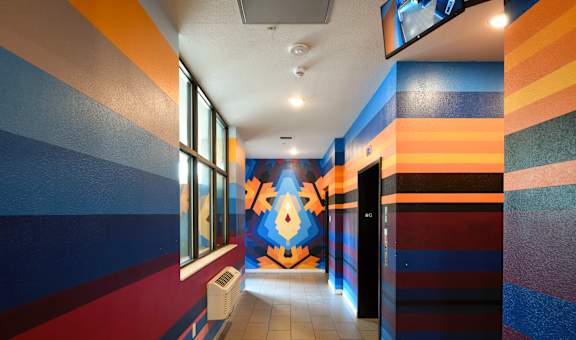 a hallway with a colorful mural on the wall