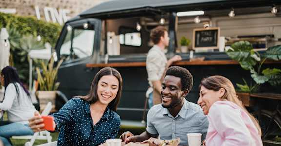 group of people sitting at a table at a food truck at Ellis Station, Durham, North Carolina